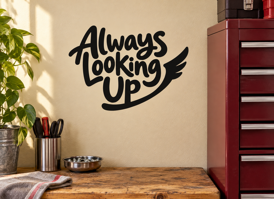Vinyl wall decal reading “Always Looking Up” in black script with wing graphic