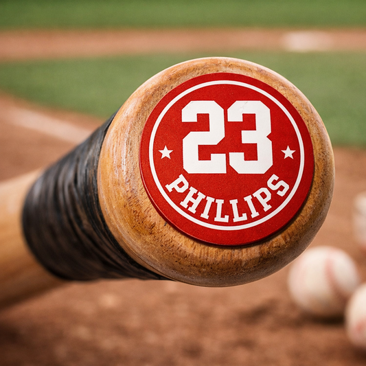 Round red Phillies 23 bat knob sticker on a wooden bat handle