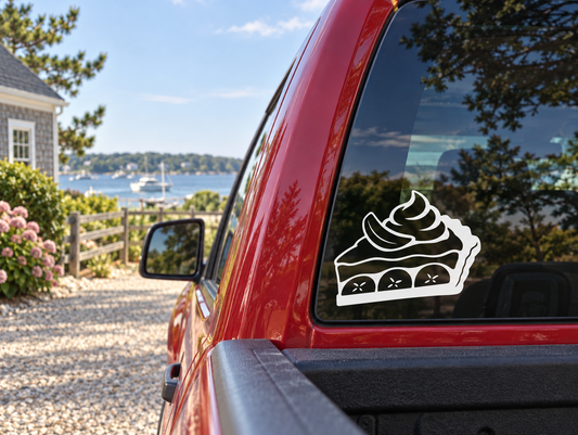 Banana cream pie slice vinyl decal with white outline and black fill, on car rear window