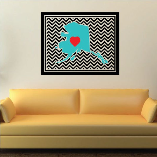 Alaska chevron sticker with teal map silhouette and red heart on black zigzag background