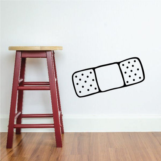 Bandage outline decal with black border and white pads with dotted detail