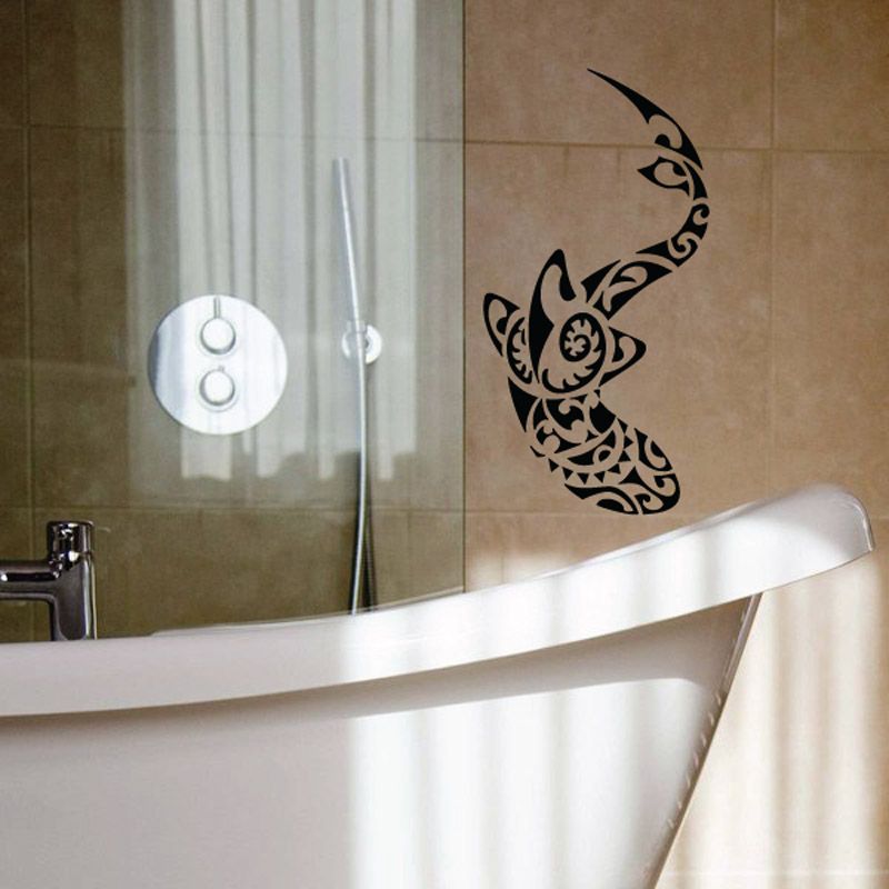 Tribal shark swimming wall decal, black stylized fin and tail above bathtub.