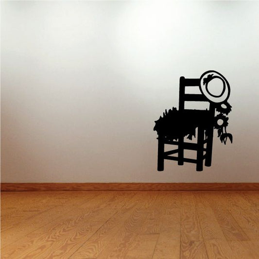 Black vinyl wall decal of a chair with circular speaker-like element and small figures
