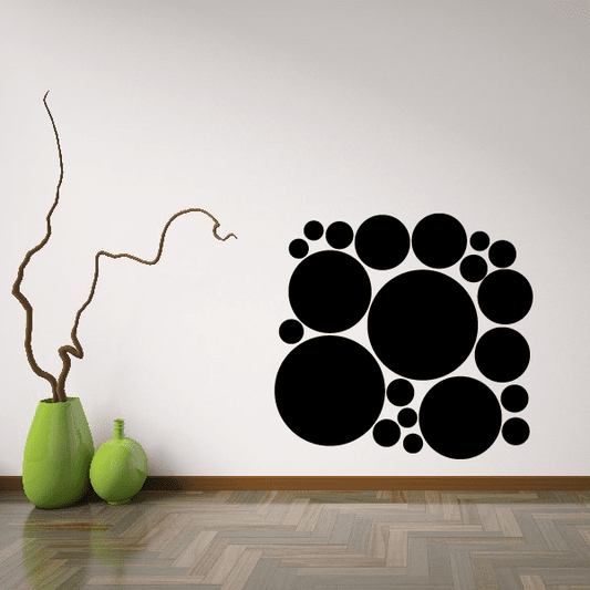 Wall decal kit with arranged black circles and dots