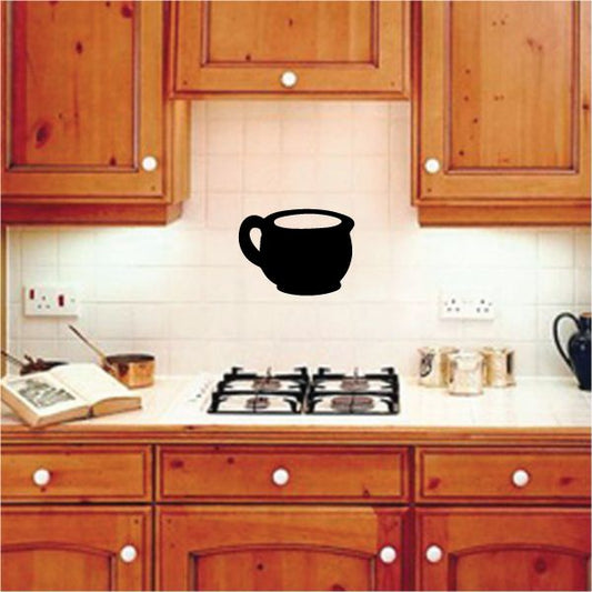 Black cup handle decal on light white tile backsplash