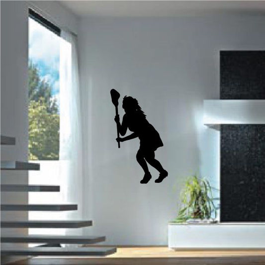 Black female lacrosse player decal silhouette holding a stick in a running pose.