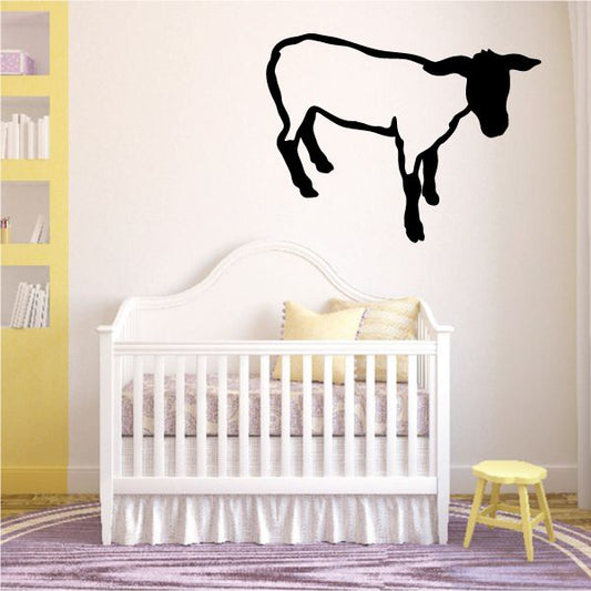 Standing sheep wall decal with black silhouette, arched legs and head turned right