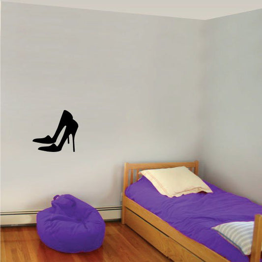 Black high heels decal silhouette on wall.