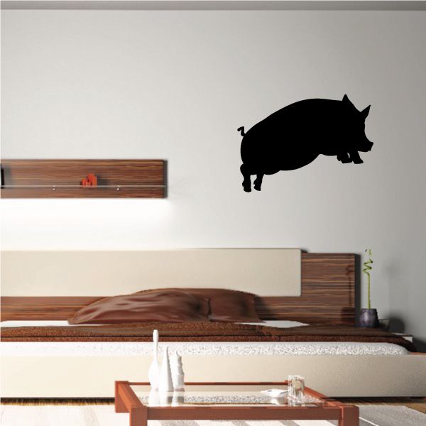 Black jumping pig silhouette wall decal with curly tail and raised snout