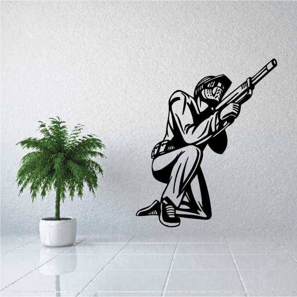 Kneeling paintball player wall decal, black and white graphic holding a marker gun