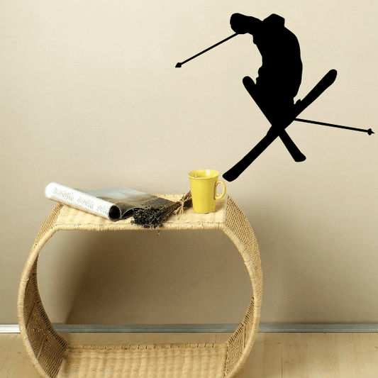 Ski trick decal featuring a black silhouette skier with crossed skis on a wall