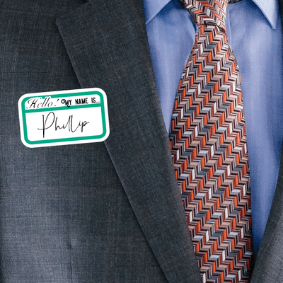 A person in business attire sporting a name tag sticker from the Name Tag Stickers set