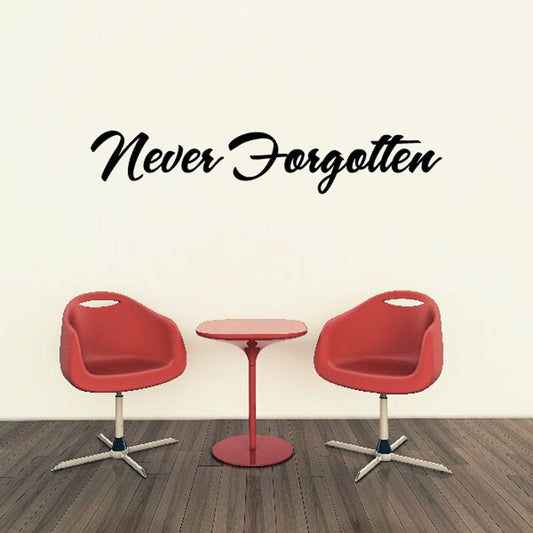Wall vinyl decal reading “Never Forgotten” with two red chairs and table