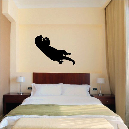 Otter eating wall decal, solid black otter silhouette