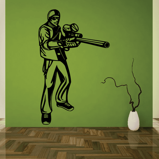 Paintball wall decal of a player holding a marker with speckled smoke trail