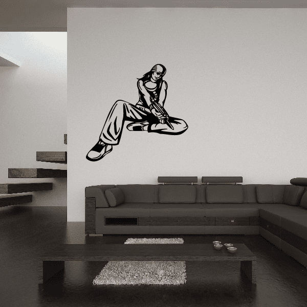 Paintball player wall decal, black vinyl silhouette of a kneeling shooter aiming forward
