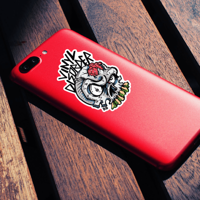 A red iPhone adorned with a skull-themed phone sticker