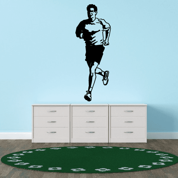 Runner wall vinyl decal with black silhouette and sneaker footprints on green base