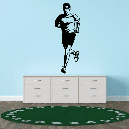 Runner wall vinyl decal with black silhouette and sneaker footprints on green base