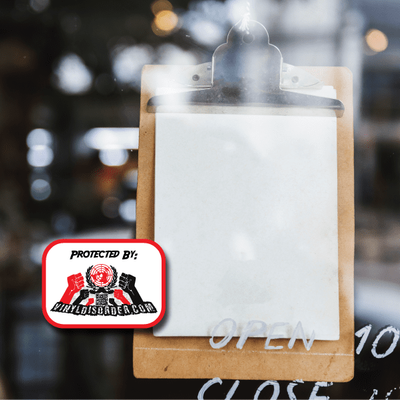 A security sticker on a clipboard attached to a window