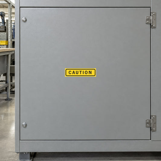 Rectangular caution sticker with yellow border and black CAUTION text