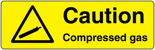 Caution compressed gas sticker with warning triangle and bold text on yellow background