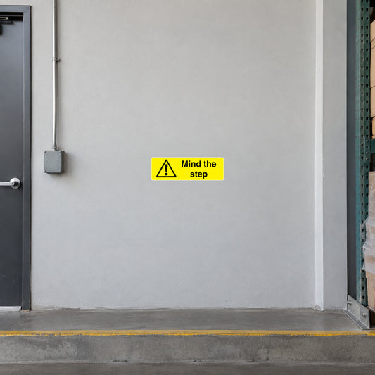 Yellow step warning sticker with exclamation icon and 'Mind the step' text