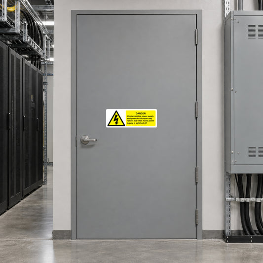 Yellow danger warning sticker with black lightning bolt on metal door