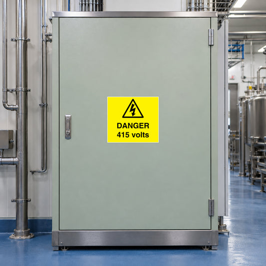 Yellow warning sticker with black triangle and text 'DANGER 415 volts'