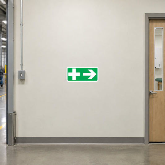 Emergency safety sticker with white cross and right arrow on green background
