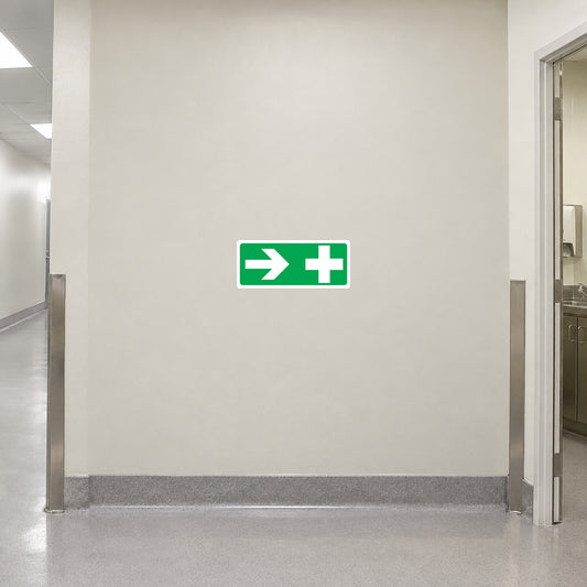 Green directional sticker with right arrow and plus symbol