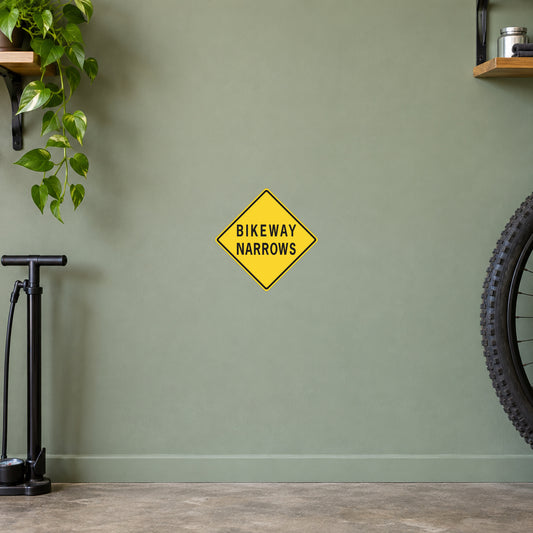 Road sign sticker with yellow diamond reading BIKEWAY NARROWS
