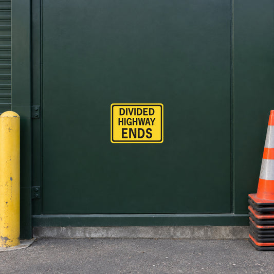 Yellow road sign sticker reading DIVIDED HIGHWAY ENDS.