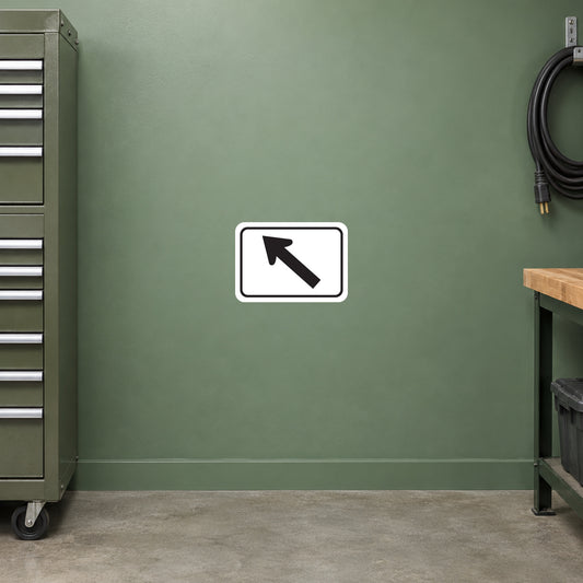 Road Sign Sticker applied in A sage green service depot equipment wall with closed tool chest far left and extension cable extreme right, smooth blank center