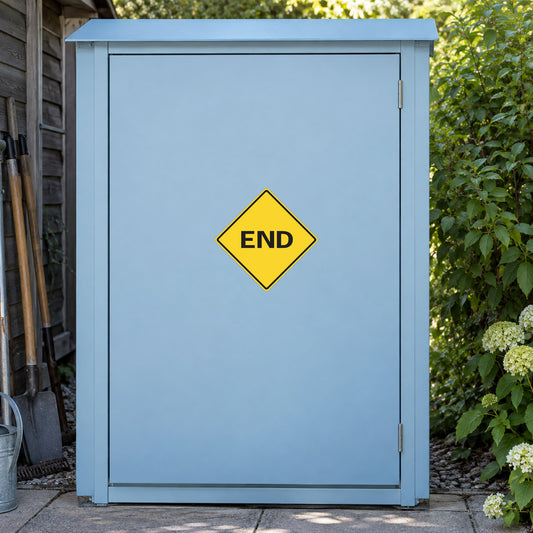 Road Sign Sticker applied in A pale blue rural property maintenance cupboard with path tools extreme left and garden greenery far right, single smooth blank door