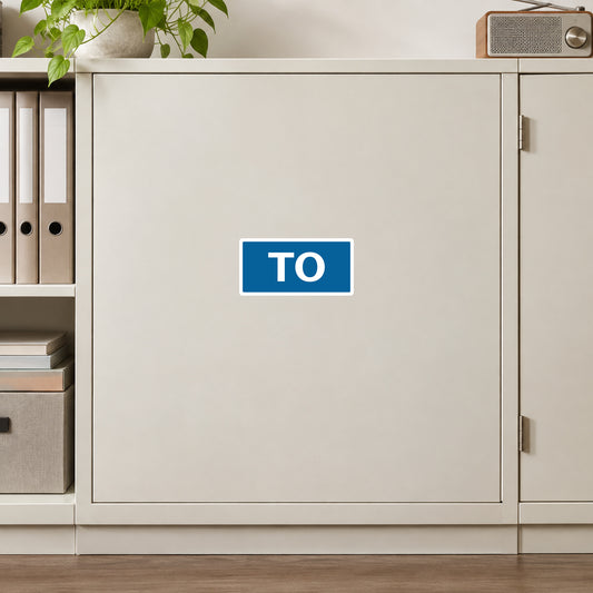 Road Sign Sticker applied in An ivory route dispatch office smooth cupboard with closed folders extreme left and tabletop radio far right, blank center door