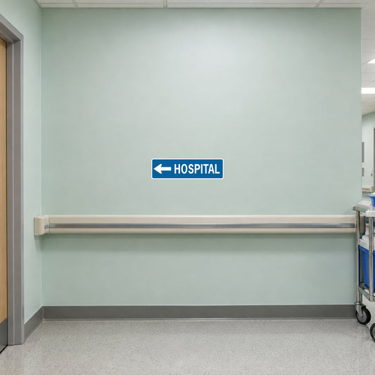 Blue road sign sticker with left arrow and “HOSPITAL” text.