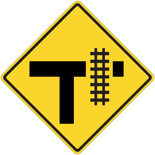 Yellow road sign sticker with black T and rail-crossing symbol