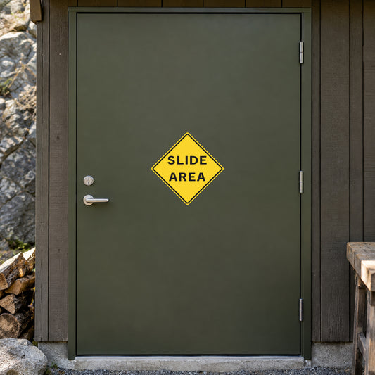 Road sign sticker with yellow diamond and SLIDE AREA text