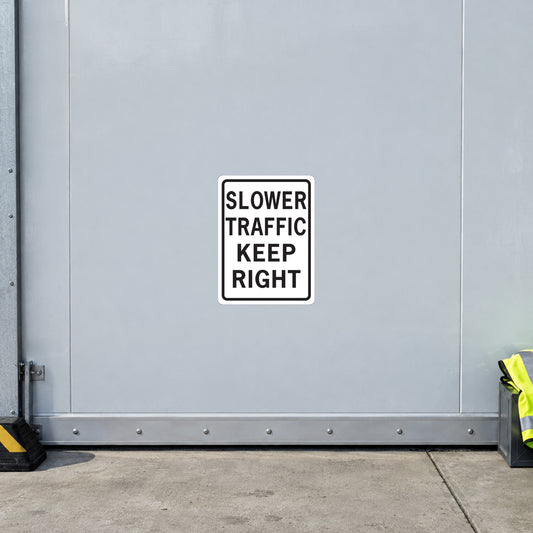 Square road sign sticker, white with black text: SLOWER TRAFFIC KEEP RIGHT