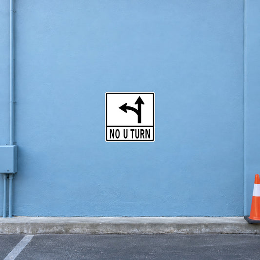 Road sign sticker showing black U-turn arrows and the text "NO U TURN"