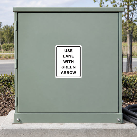 Road sign sticker with "USE LANE WITH GREEN ARROW" text