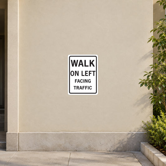 Road sign sticker with WALK ON LEFT facing traffic text, white square with black border