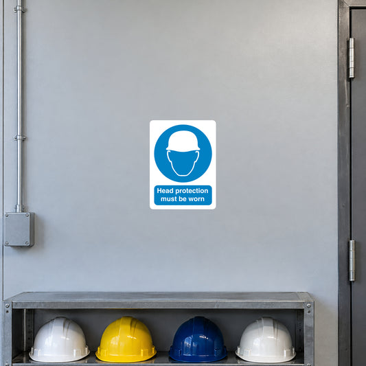 Safety sign sticker with blue head protection icon and text: Head protection must be worn