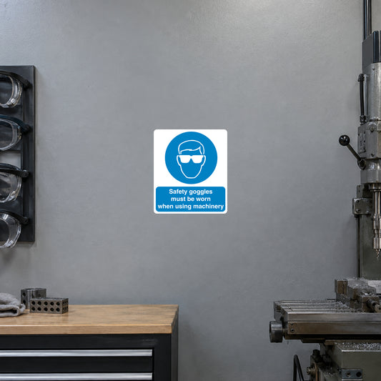 Safety sign sticker: blue goggles icon on white square with small warning text