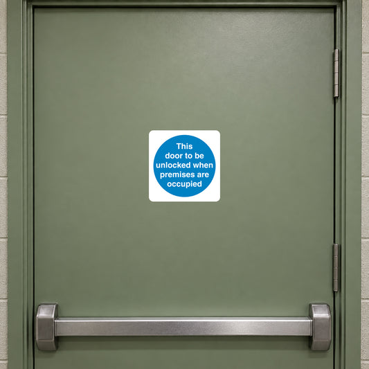 Safety Sign Sticker applied in a smooth sage closed fire escape door in a small public venue, push bar outside central area at bottom y85 and frame far edges