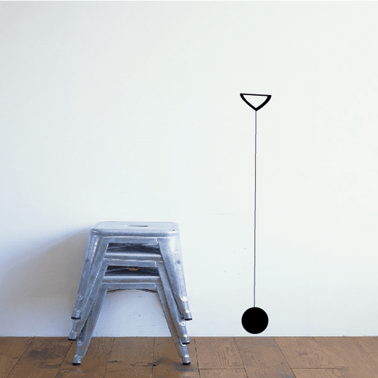 Wall decal with thin vertical line, outlined triangle top and black circle bottom