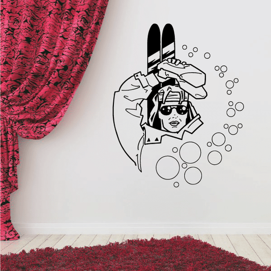 Skiing wall decal with cartoon skier face, goggles, skis, and circular snow bubbles