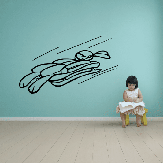 Ski racing vinyl wall decal with black skier illustration in motion lines
