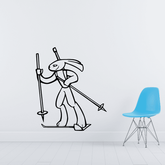 Skiing wall decal with cartoon skier holding poles and skis, vinyl sticker